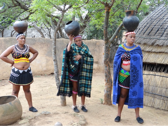 Zulu girls demostrate how to carry the Zulu pots during our Tour from Durban