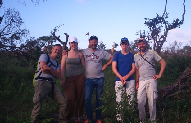 Picture of client on bush walk with Giraffe behind them